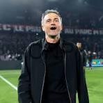 anr - Center News Network Soccer coach on the field celebrating with mouth open, wearing a black jacket, stadium lights in the background.