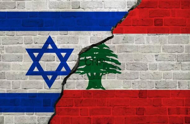Wall painted with the Israeli flag on the left and the Lebanese flag on the right, cracked down the middle.