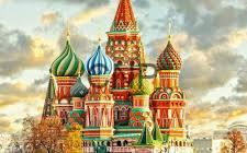 Colorful onion domes of Saint Basil's Cathedral against a cloudy sky in Moscow, Russia.