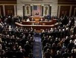 Congress in session with a speaker at the podium and lawmakers seated in rows inside a grand chamber, flags behind the dais.