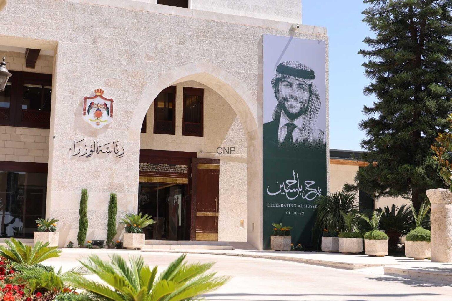 pry - Center News Network Exterior view of a beige stone building with an arched entrance and a large banner banner featuring a man in a keffiyeh and suit