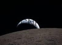 sp - Center News Network Earthrise over the Moon's cratered surface, with Earth peeking above the lunar horizon.