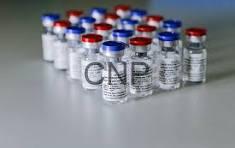vax - Center News Network Row of small glass vials with red and blue caps lined up on a sterile lab surface, likely vaccines or medications.