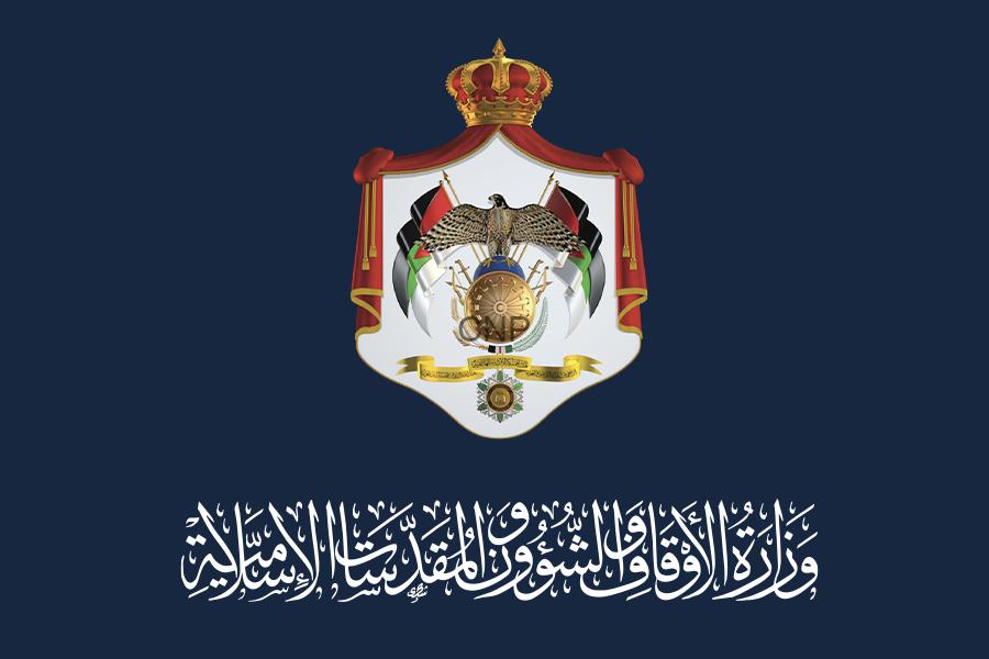 awq - Center News Network Official government crest on a dark blue background, featuring a crowned shield with an eagle, flags, and Arabic script beneath.