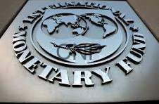 bank - Center News Network Metal plaque featuring a circular emblem with a globe and a winged symbol, surrounded by large raised lettering. The plaque appears silver on a dark background.