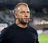 bar - Center News Network A middle-aged man in a black athletic shirt on a football pitch, looking ahead with a stadium in the background.