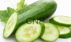 cuc - Center News Network Fresh cucumbers with several slices arranged on a white background.