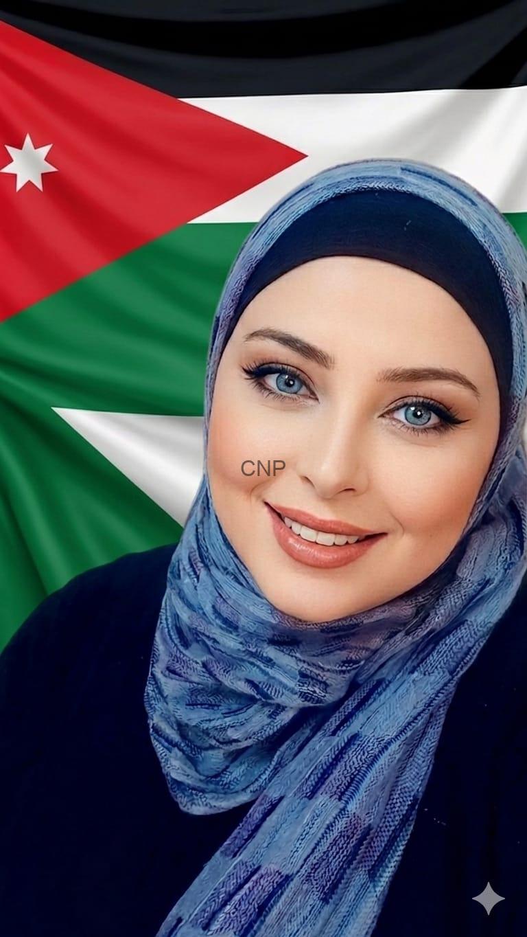 Portrait of a smiling woman wearing a blue hijab, with the Jordanian flag in the background.