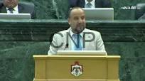hma - Center News Network Male official delivering a speech at a lectern in a formal legislative chamber.