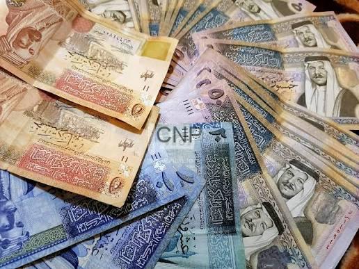 images 11 - Center News Network Assorted banknotes from different countries spread out on a surface.