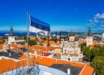 ist - Center News Network Israeli flag waving over a red-tiled rooftop, with a sunny historic city skyline in the distance.