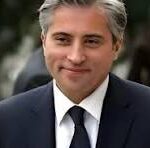 Man in a dark suit and tie, outdoors, with a neutral expression (watermark 'CNP' visible).