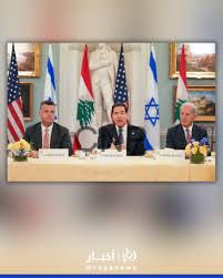 lui - Center News Network Three diplomats seated behind a conference table with microphones, flanked by US, Lebanese, Japanese, and Israeli flags in the background for a formal meeting.