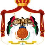 man - Center News Network National emblem-inspired crest with a crown, red drapery, two supporters, and a shield showing the orange Ashoka Chakra wheel.