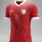 Red soccer jersey with white trim and team crest on the chest; Puma logo on the right and 'CNP' sponsor text across the front.