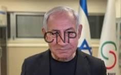 net - Center News Network Older man with white hair in a dark suit, standing in front of flags; 'CNP' watermark across his face.