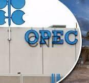opec - Center News Network OPEC sign on a beige building wall with a blue logo against a blue sky.