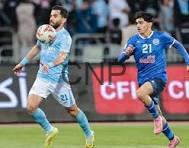 ram - Center News Network Soccer player in light blue controls the ball as a blue-clad opponent pursues.