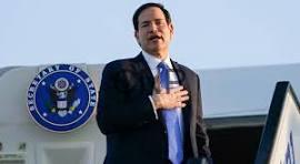 rob - Center News Network Man in a dark suit giving a speech at a podium, hand over heart, with a government seal visible in the background.
