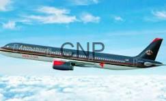 roy - Center News Network Passenger jet in flight above clouds, dark fuselage with red engine nacelles against a blue sky.