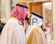 sa b - Center News Network Two men in traditional Middle Eastern dress (thobes and ghutras) chatting indoors at an event.