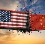 Banner showing the US flag on the left and the Chinese flag on the right tearing apart in midair at sunset, symbolizing US–China tension or competition.