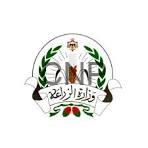 zzz - Center News Network Official emblem featuring a green laurel wreath surrounding an open book and scales, with a crown on top and a banner bearing Arabic text.