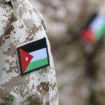 Close-up of a soldier's camouflage sleeve with a Jordan flag patch visible on the shoulder.