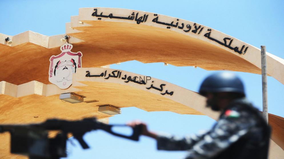 الكرامة - Center News Network Security checkpoint at Jordan's border with a soldier in the foreground and the Hashemite Kingdom of Jordan arch in Arabic above.