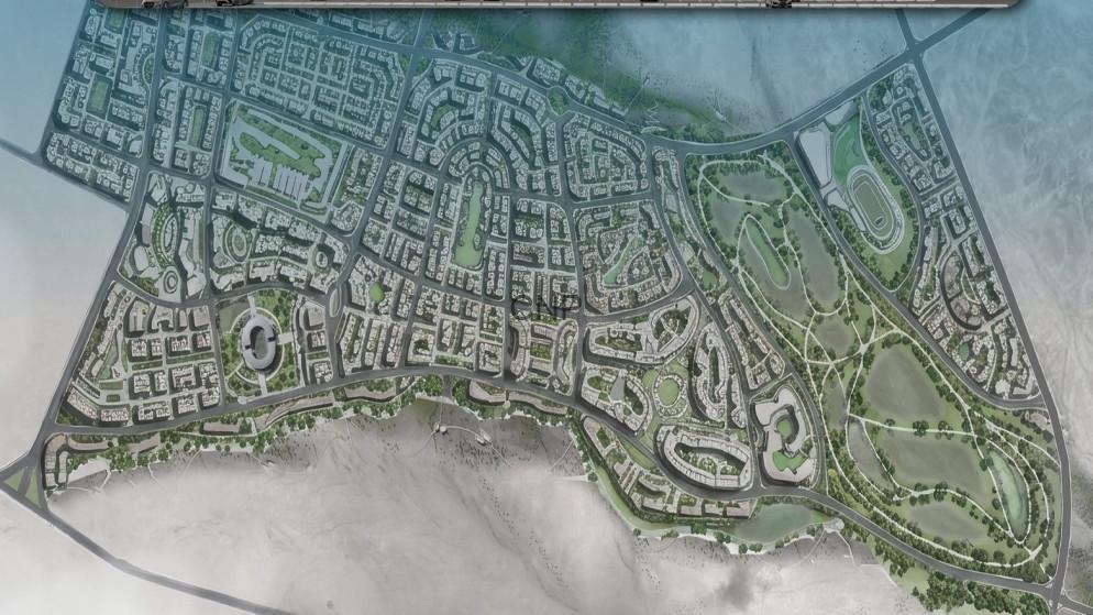 PARKAM - Center News Network Aerial view of a coastal city with dense streets and a large golf course to the east.