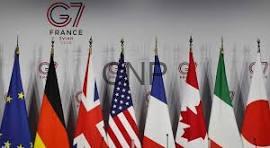 SAB - Center News Network Row of national flags in front of a G7 France summit backdrop on a stage