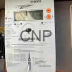 Close-up of a white electronic control panel with a digital display and orange buttons, labeled CNP.