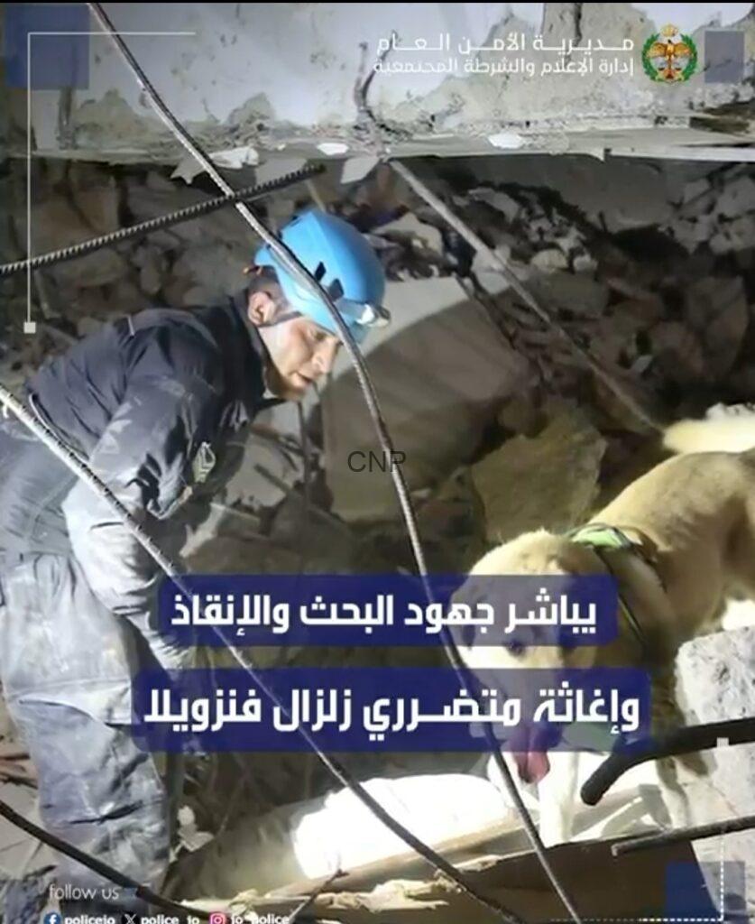 ss3 - Center News Network Rescue worker in a blue helmet searches rubble in a collapsed building; Arabic news banner overlays the scene with a dog nearby.
