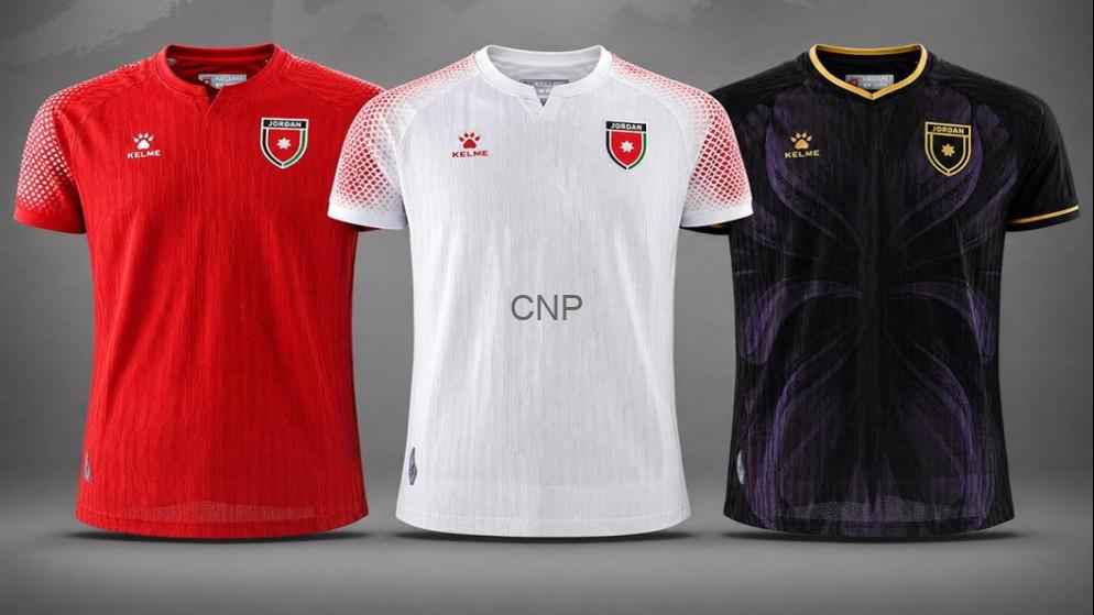 Three soccer jerseys in red, white, and black lined up side by side, each with a crest on the chest and brand logos.