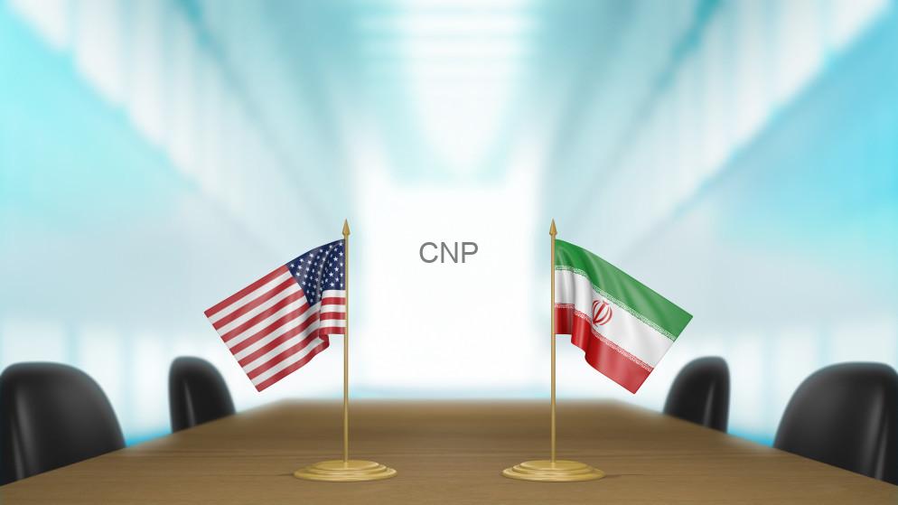 Two national flags (USA and Iran) mounted on a conference table in a bright meeting room, with 'CNP' displayed between them on a white screen.