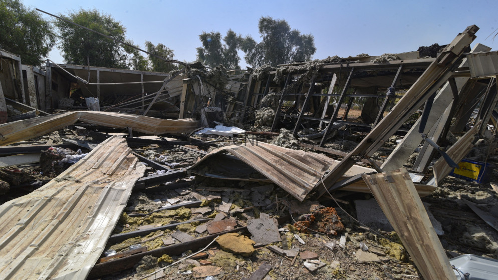 image - Center News Network Rubble and twisted metal from a collapsed building, with scattered wooden panels and debris across the ground.