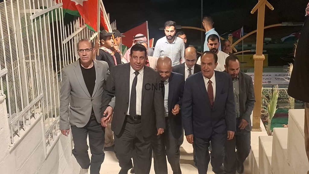 Group of formally dressed men walking down white stairs at night, flags in the background suggesting a ceremonial event.