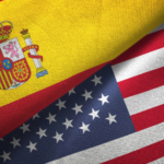 Flag collage combining the Spanish flag with the United States flag, with a faint 'CNP' watermark in the center.