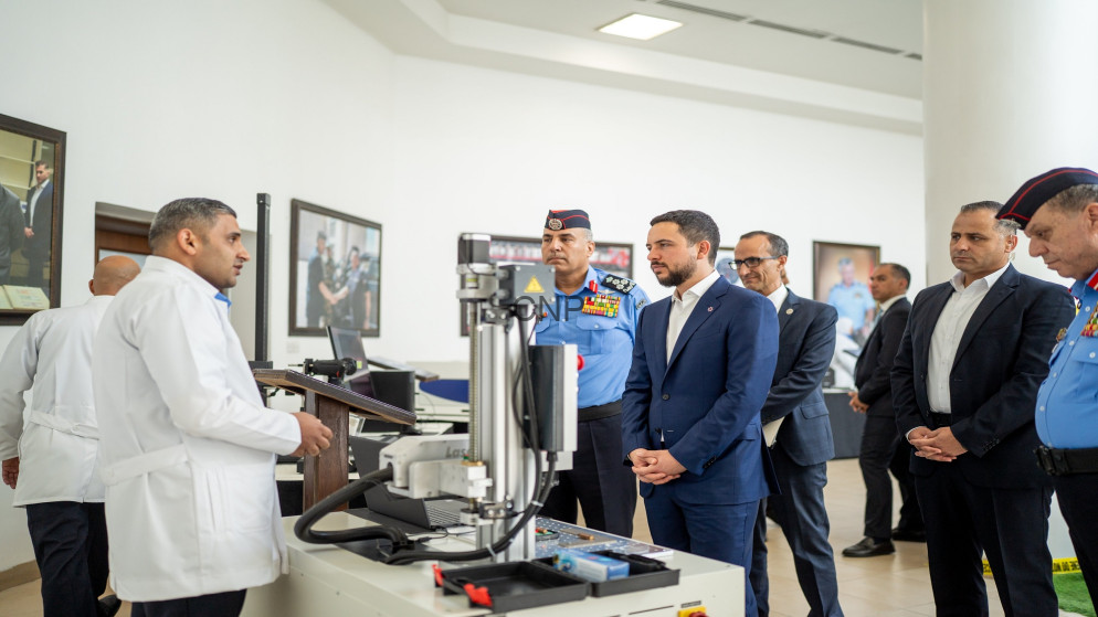 image - Center News Network Group of officials and doctors in a lab, listening to a speaker at a medical device demonstration.