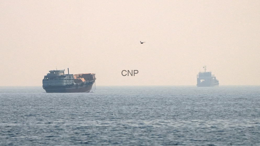 Hazy seascape with a large ship on the left and a smaller vessel on the right, a single bird in the sky, and a centered 'CNP' watermark.