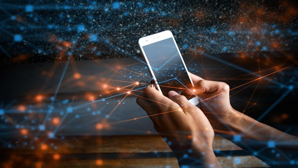 Hands holding a smartphone surrounded by glowing blue and orange network lines and particles.