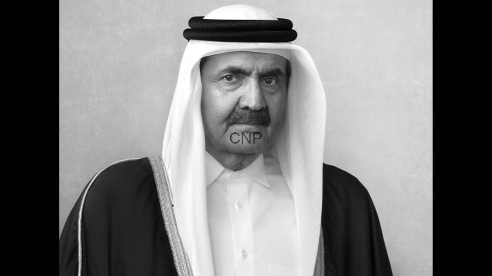 Black-and-white portrait of an older man wearing traditional Arab dress, facing the camera.
