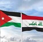 Jordan and Iraq flags waving side by side in a cloudy sky.