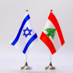 Israeli flag and Lebanese flag on small stands, displayed side by side.