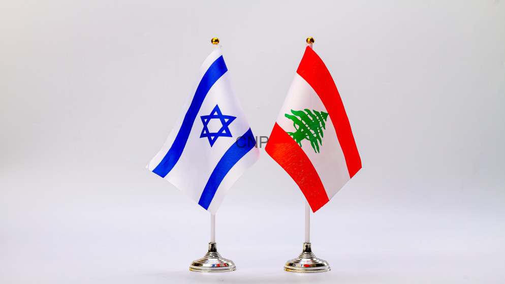 Israeli flag and Lebanese flag on small stands, displayed side by side.