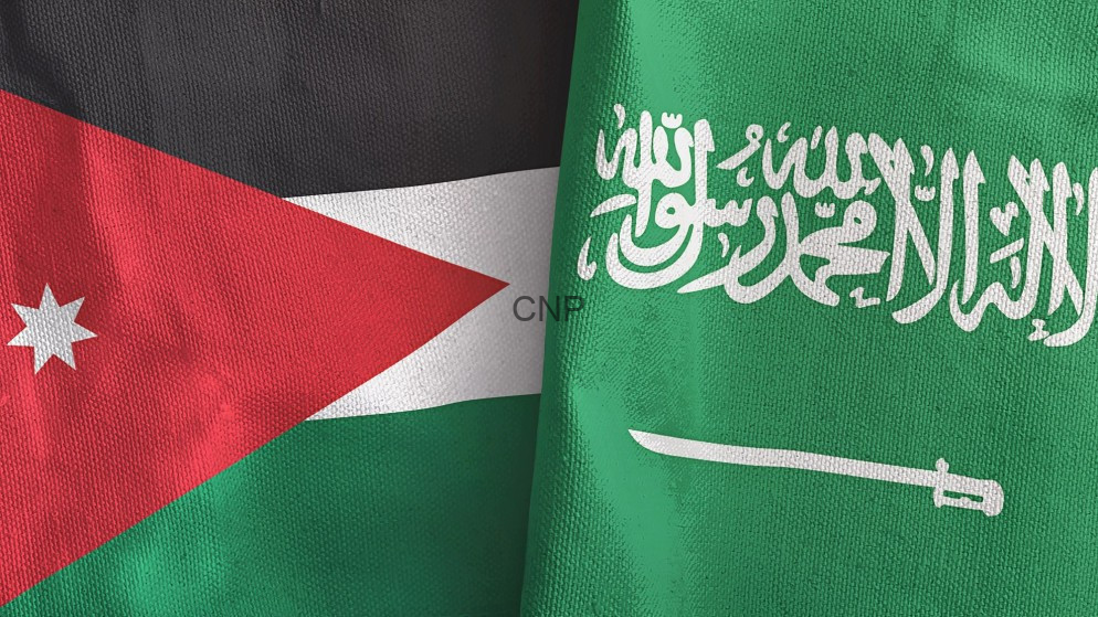 image - Center News Network Two national flags overlapped: Jordan (left) with a red triangle and white star, and Saudi Arabia (right) in green with Arabic inscription and a sword.