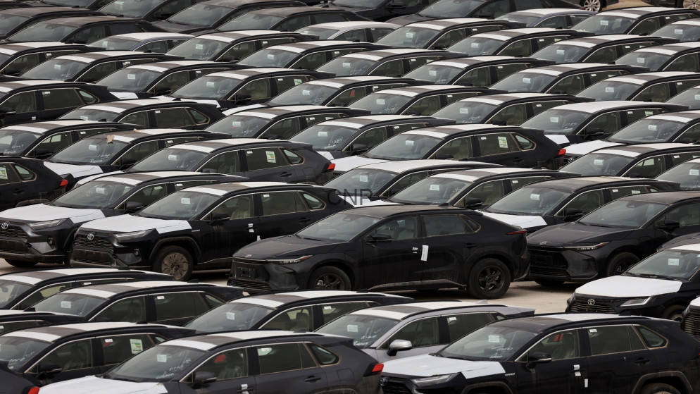 image - Center News Network Row after row of dark sedans parked in a car lot, many with protective white covers on hoods and windows