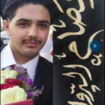 Portrait of a young man in a suit smiling, holding a bouquet of flowers at a ceremony.