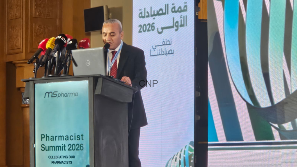 image - Center News Network Man in suit speaks at a podium with multiple microphones during Pharmacist Summit 2026, MSpharma branding visible on the lectern.